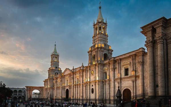 Arequipa Cathedral carved from volcanic stone, lit up at sunset